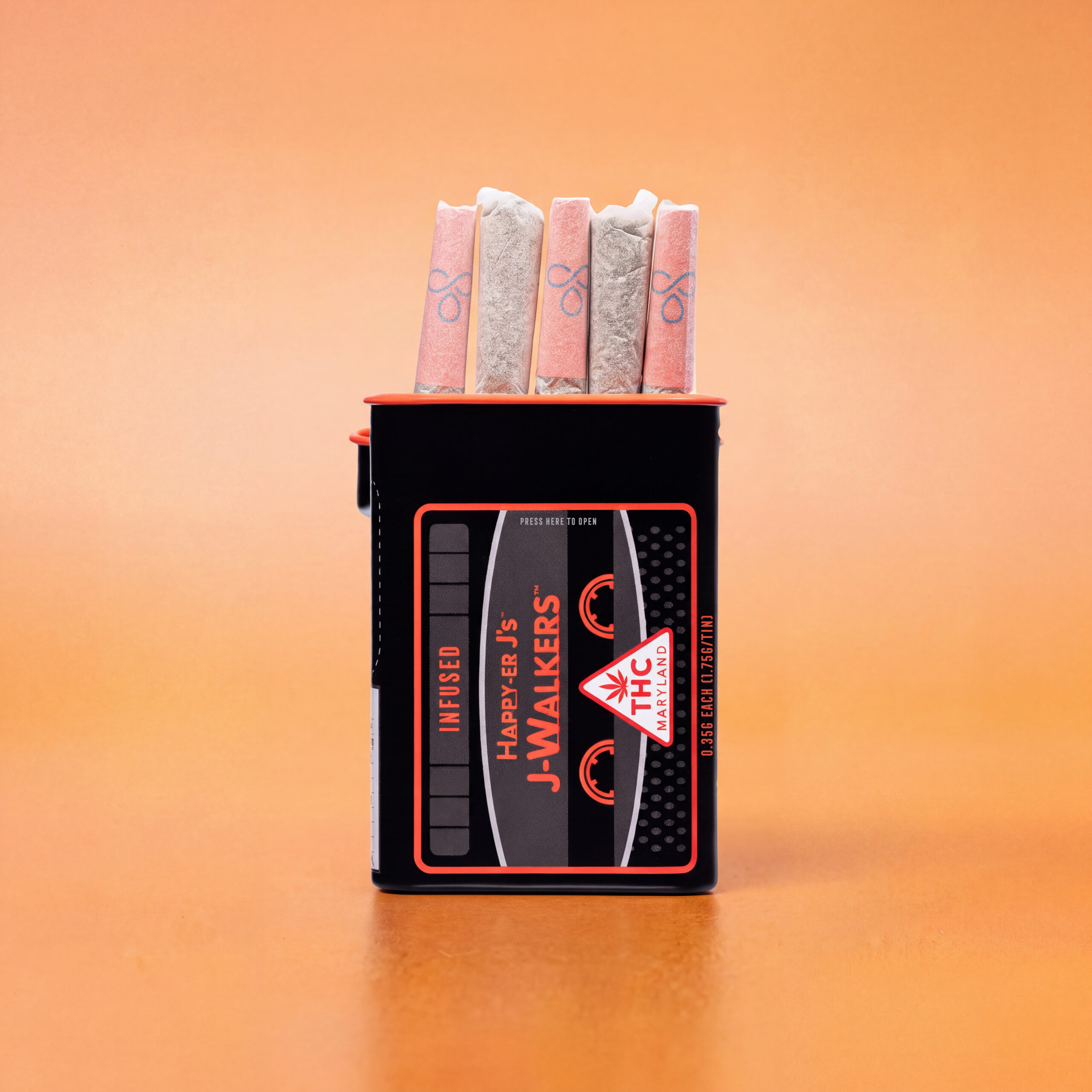 Black Happy-ER J’s J-WALKERS infused pre-roll tin containing five pre-rolls with pink and white filter tips, set against a solid orange background.